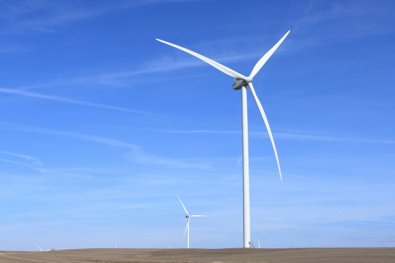 services-02 Wind turbines under a clear blue sky symbolize clean energy and sustainability.