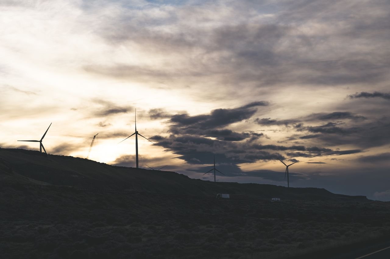 Crafting Captivating Headlines: Your awesome post title goes here Silhouette of wind turbines on a hill with a dramatic cloudy sky at sunset.